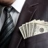 Businessman with money in suit pocket