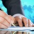 Businessman's hand with a pen. International business concept