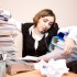 Young businesswoman with tons of documents