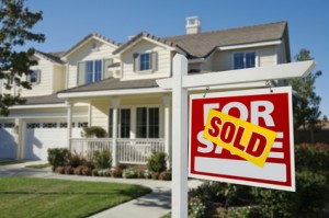 Sold Home For Sale Sign and New House